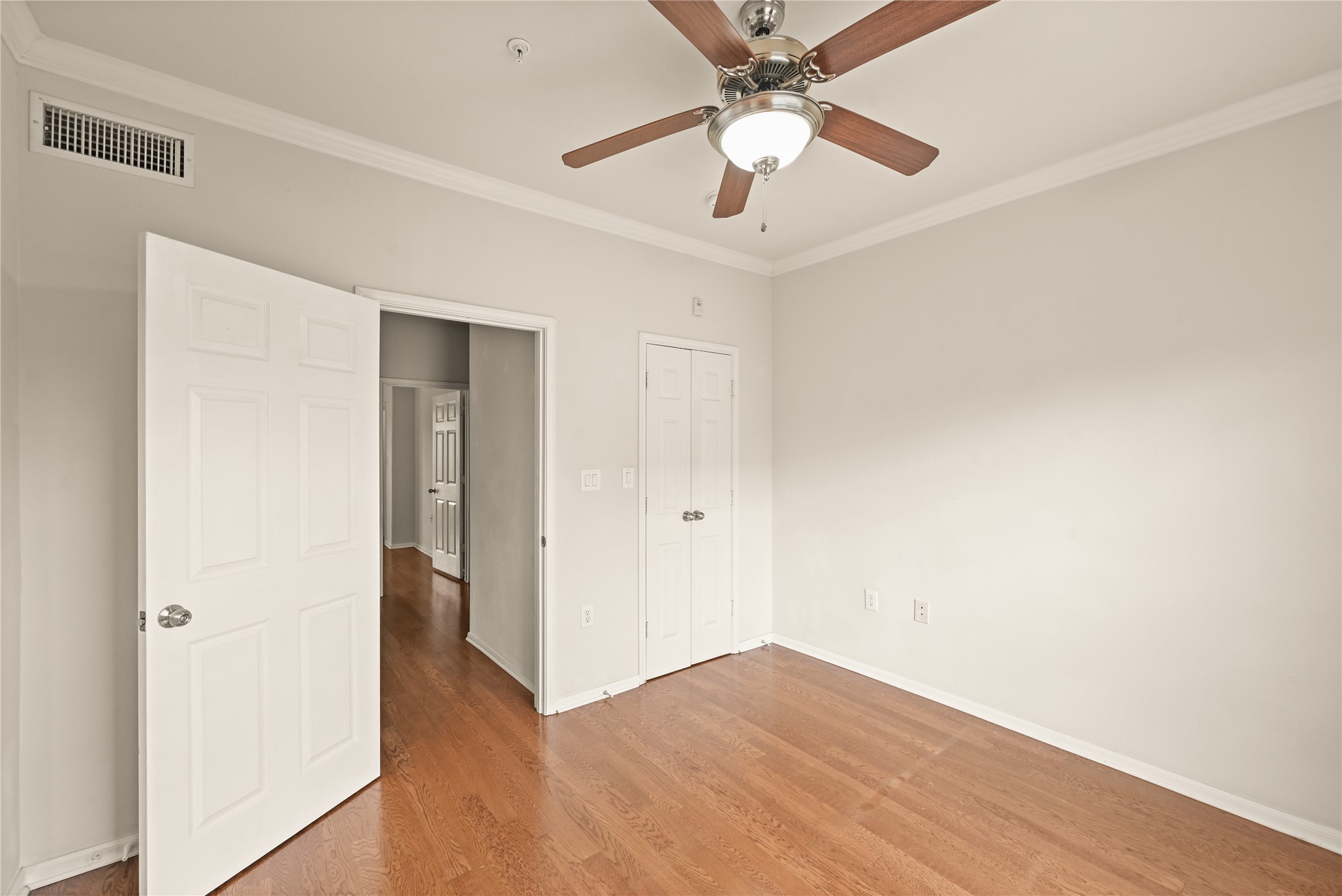 9200 Westheimer Road, Unit 706 Houston, TX 77063 - Photo 27 of 43 an empty room with wooden floor and ceiling fan