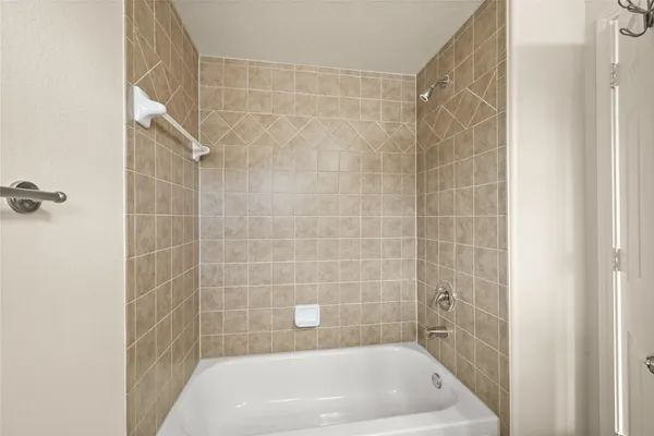 a bath tub sitting next to a white sink