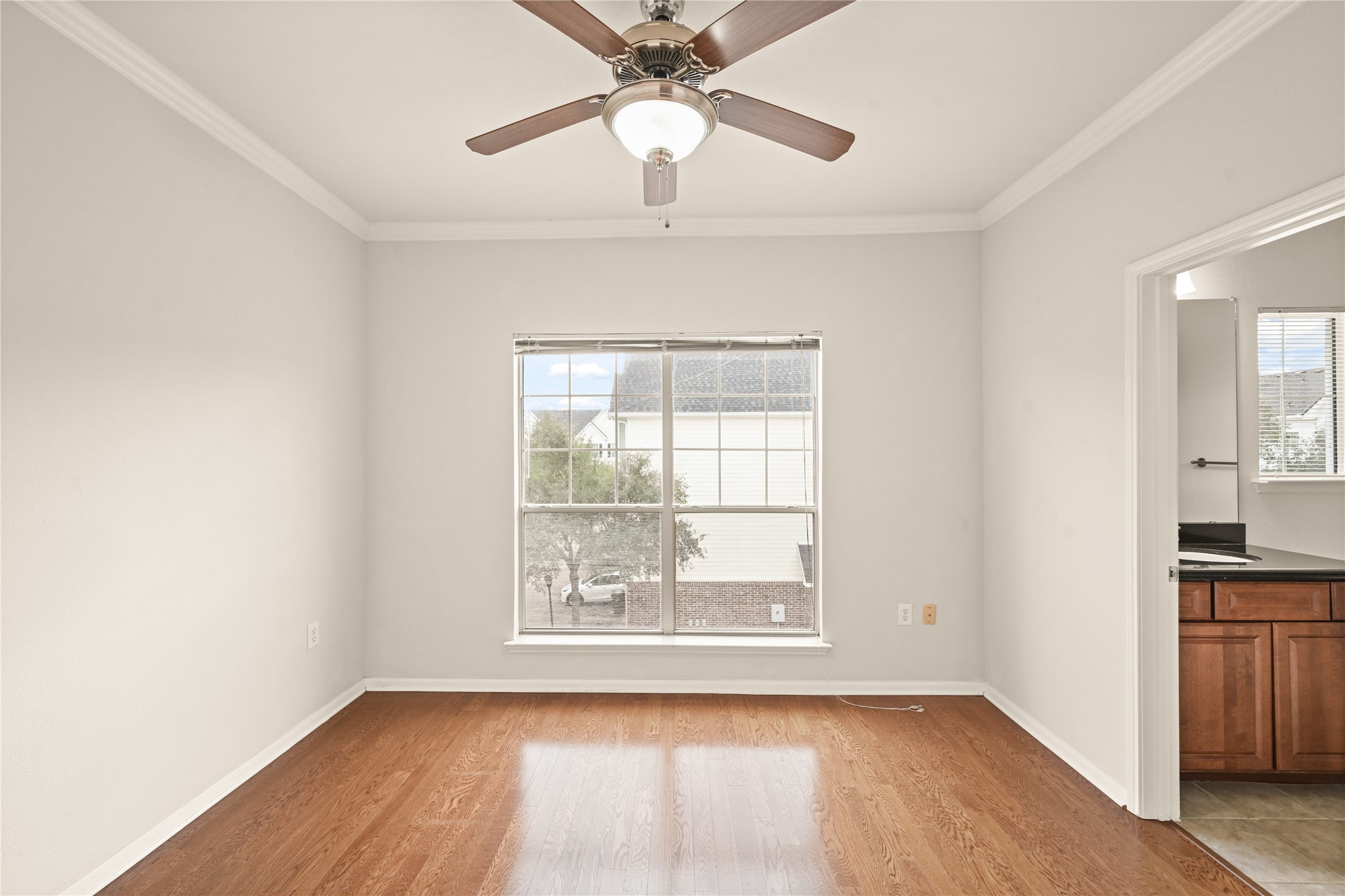 9200 Westheimer Road, Unit 706 Houston, TX 77063 - Photo 31 of 43 an empty room with wooden floor fan and windows