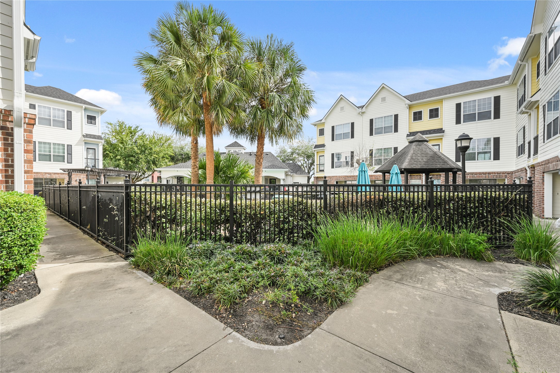 9200 Westheimer Road, Unit 706 Houston, TX 77063 - Photo 36 of 43 a front view of a house with a garden