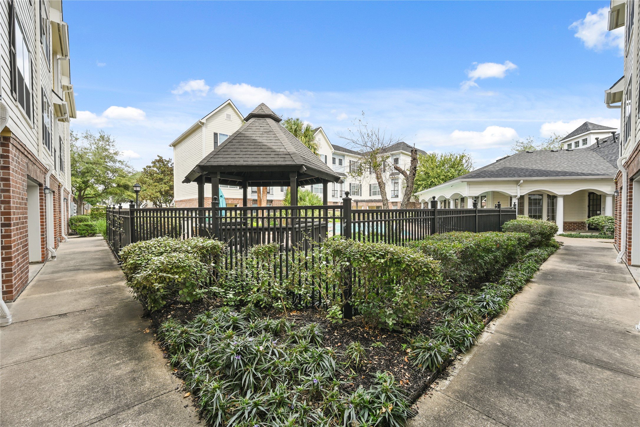 9200 Westheimer Road, Unit 706 Houston, TX 77063 - Photo 40 of 43 a front view of a house with a garden