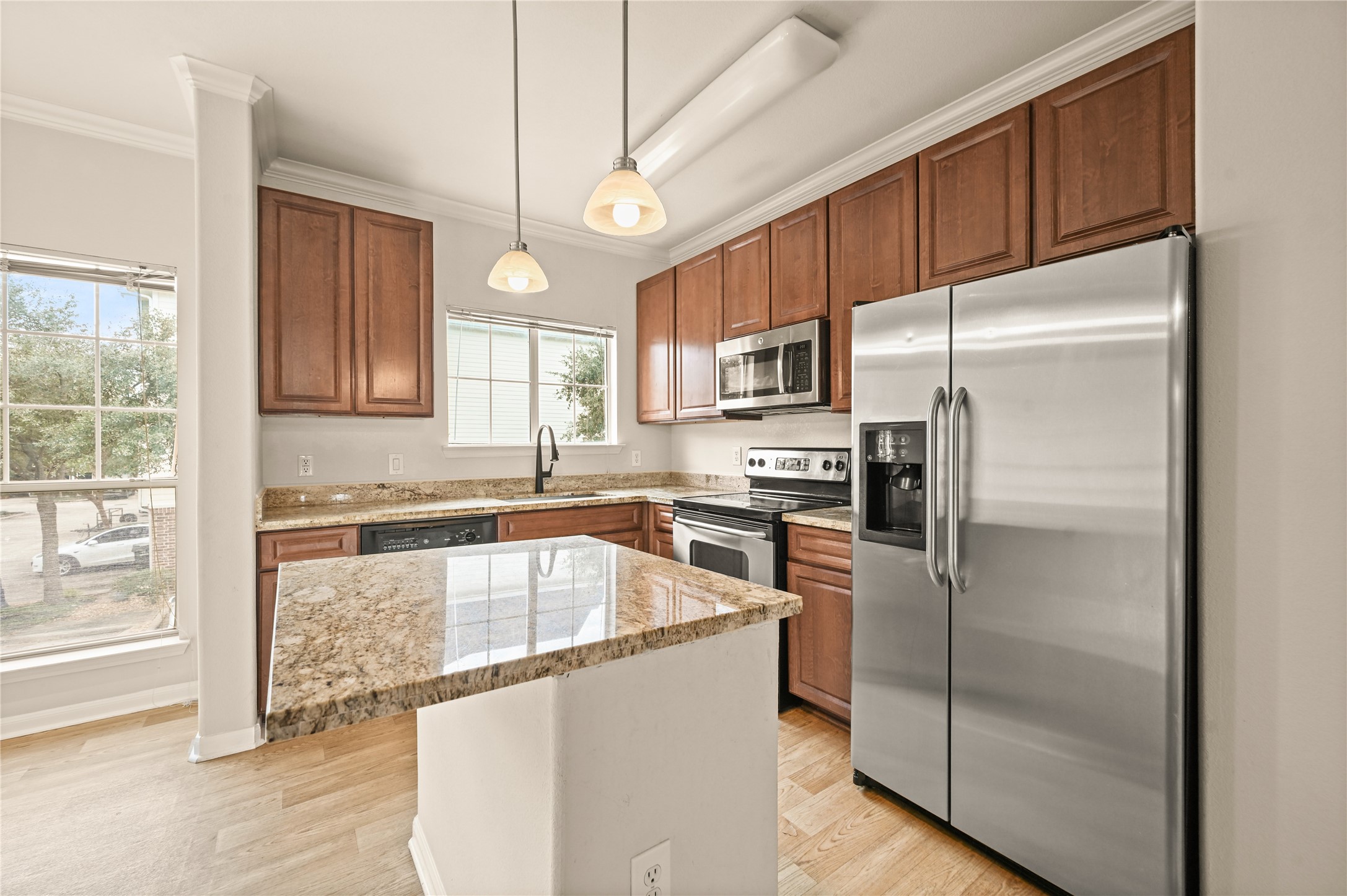 9200 Westheimer Road, Unit 706 Houston, TX 77063 - Photo 6 of 43 a kitchen with a refrigerator a sink and cabinets