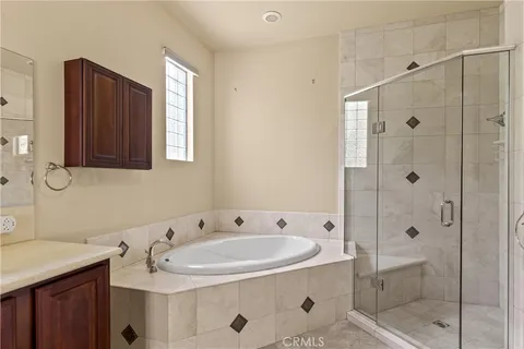 a bathroom with a sink and mirror with shower