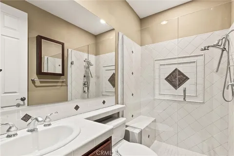 a bathroom with a sink toilet and shower