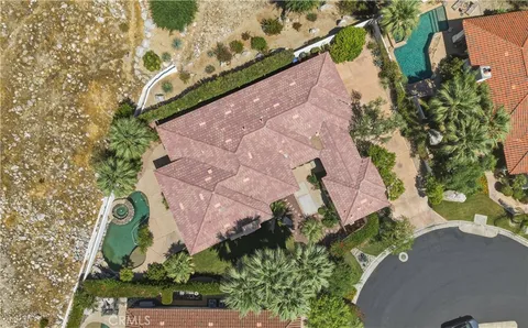 an aerial view of a house with a yard and garden