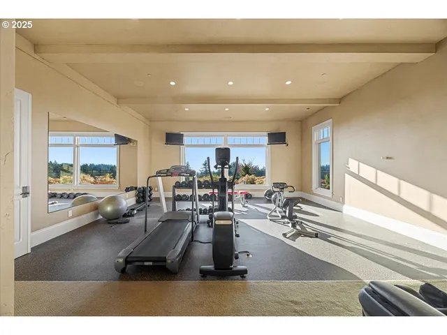 a room with gym equipment and large mirror