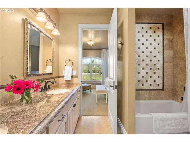 a bathroom with a granite countertop sink mirror and shower