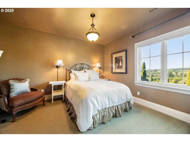 a bedroom with a bed lamps and window