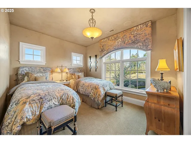 a bedroom with furniture and a large window