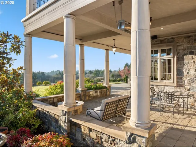 a view of a porch with furniture and floor to ceiling window