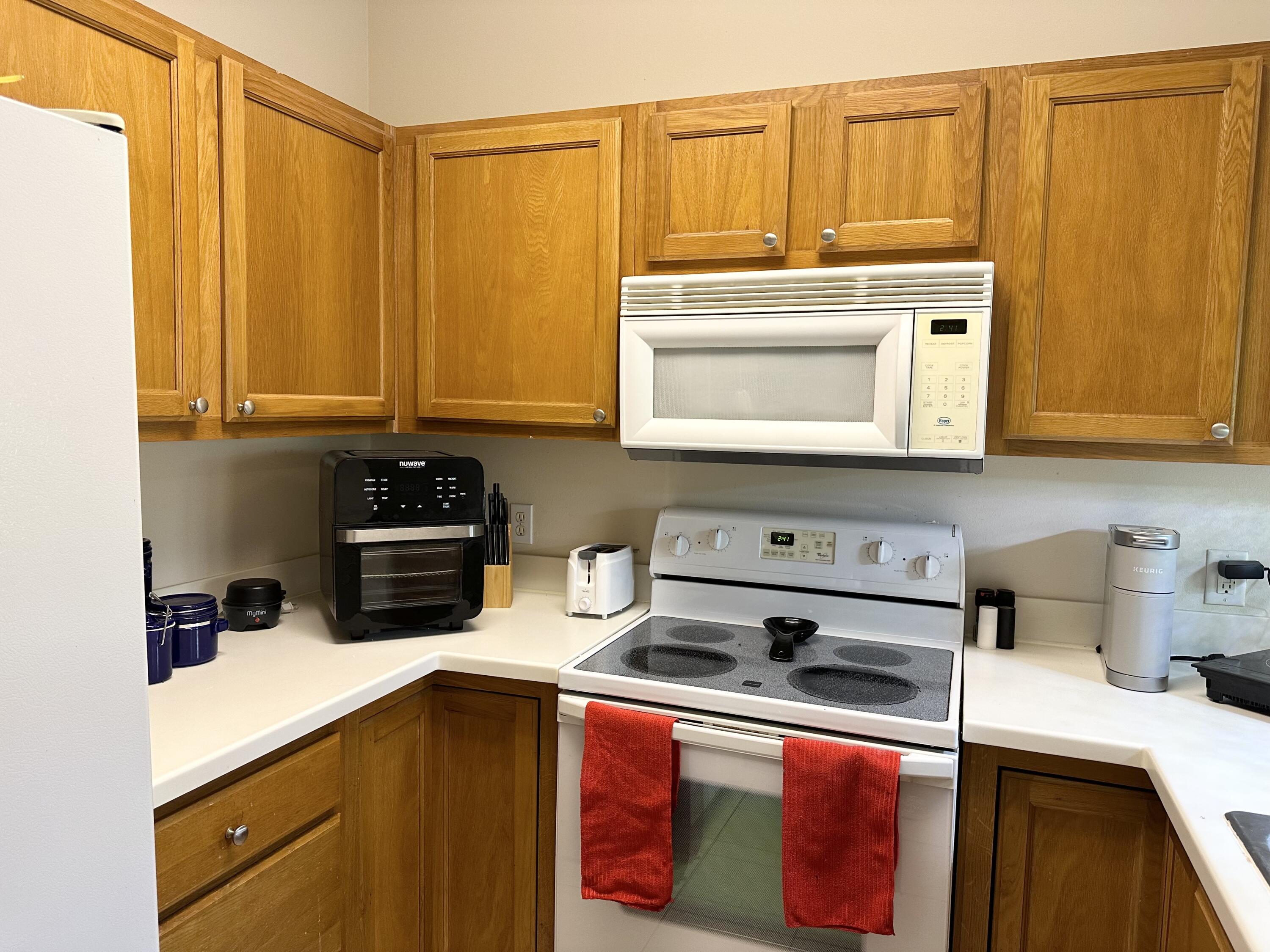 732 East Mack Bayou Drive, Unit 2 Santa Rosa Beach, FL 32459 - Photo 14 of 43 a kitchen with stainless steel appliances a stove a microwave and sink
