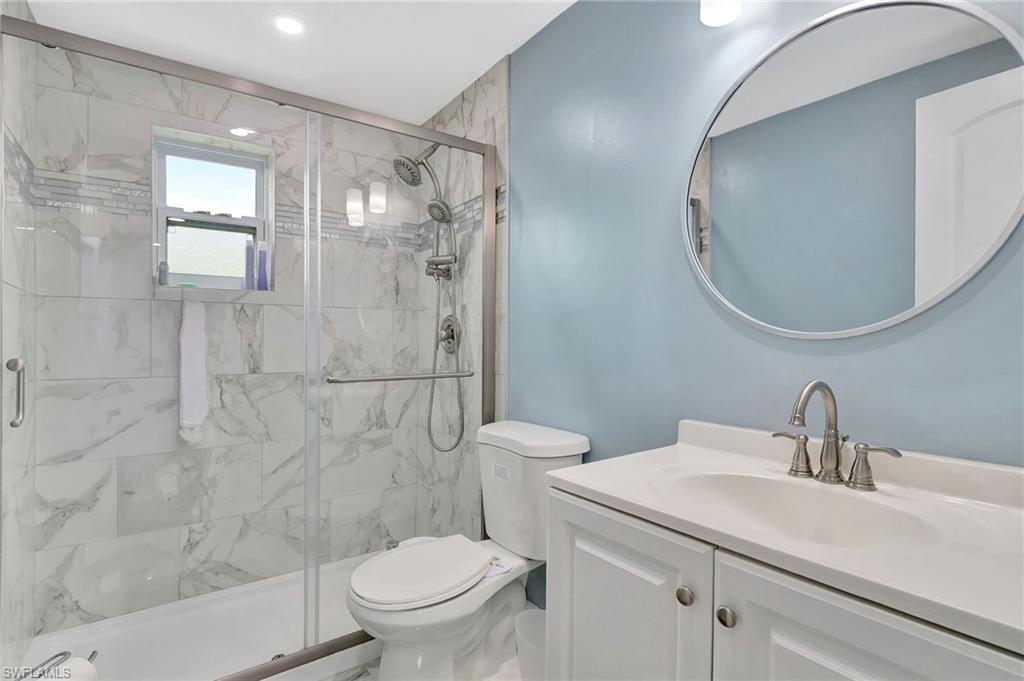 1009 Ridge Street Naples, FL 34103 - Photo 26 of 30 Full bath featuring vanity and a marble finish shower