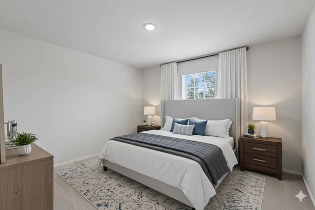 a bedroom with a bed and a potted plant