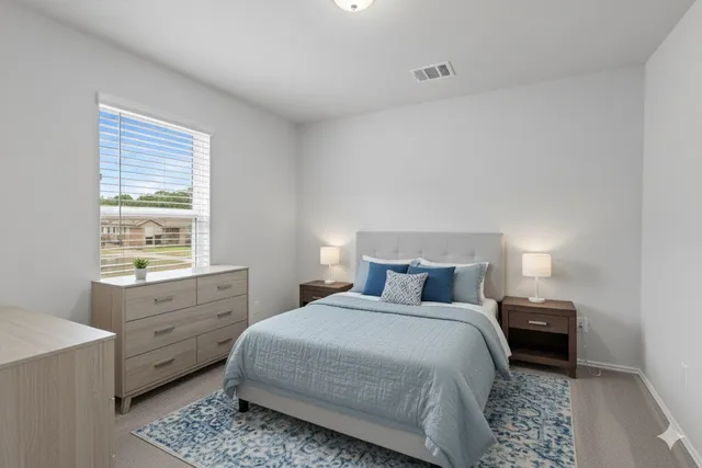 a bedroom with a bed and a window