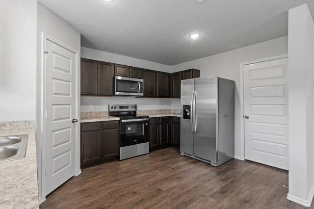 a kitchen with a refrigerator stove and a sink
