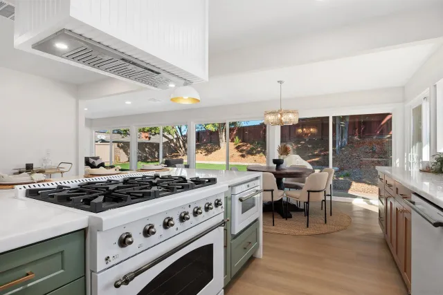 a kitchen with stove and cabinets