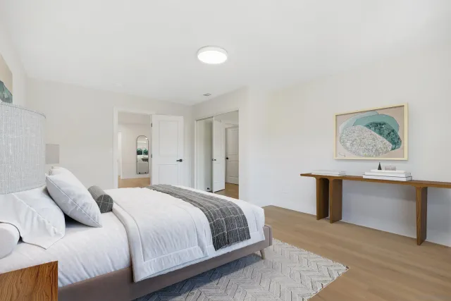 a bedroom with a bed and a desk