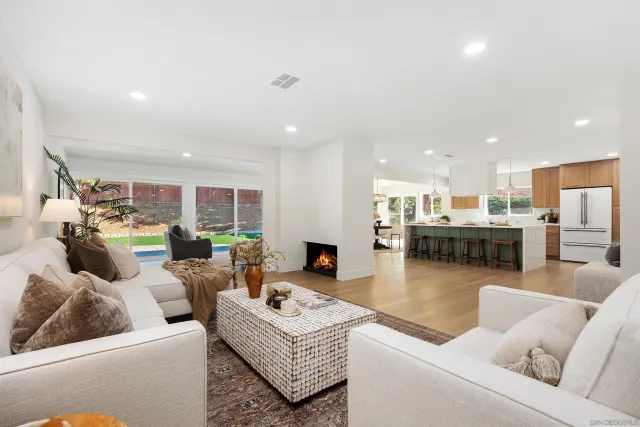 a living room with furniture and kitchen view