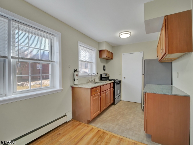 153 Ridge Road, Unit D Cedar Grove, NJ 07009 - Photo 9 of 21 a room with window and wooden floor
