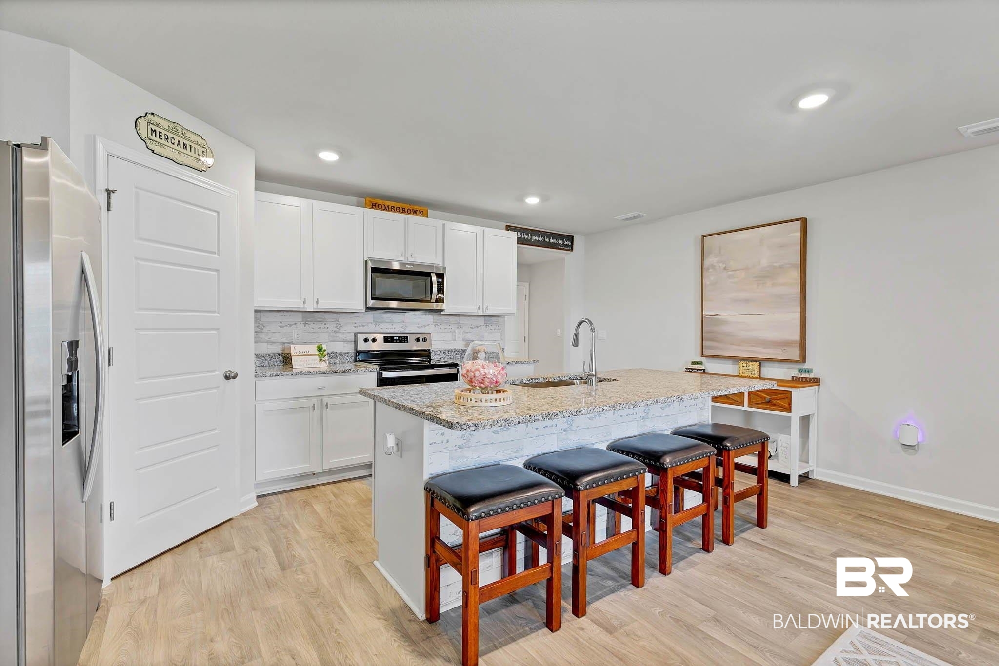 17217 REFLECTION Street Loxley, AL 36551 - Photo 10 of 83 Kitchen with stainless steel appliances, light wood-style lvp flooring, granite countertops white cabinetry, and recessed lighting