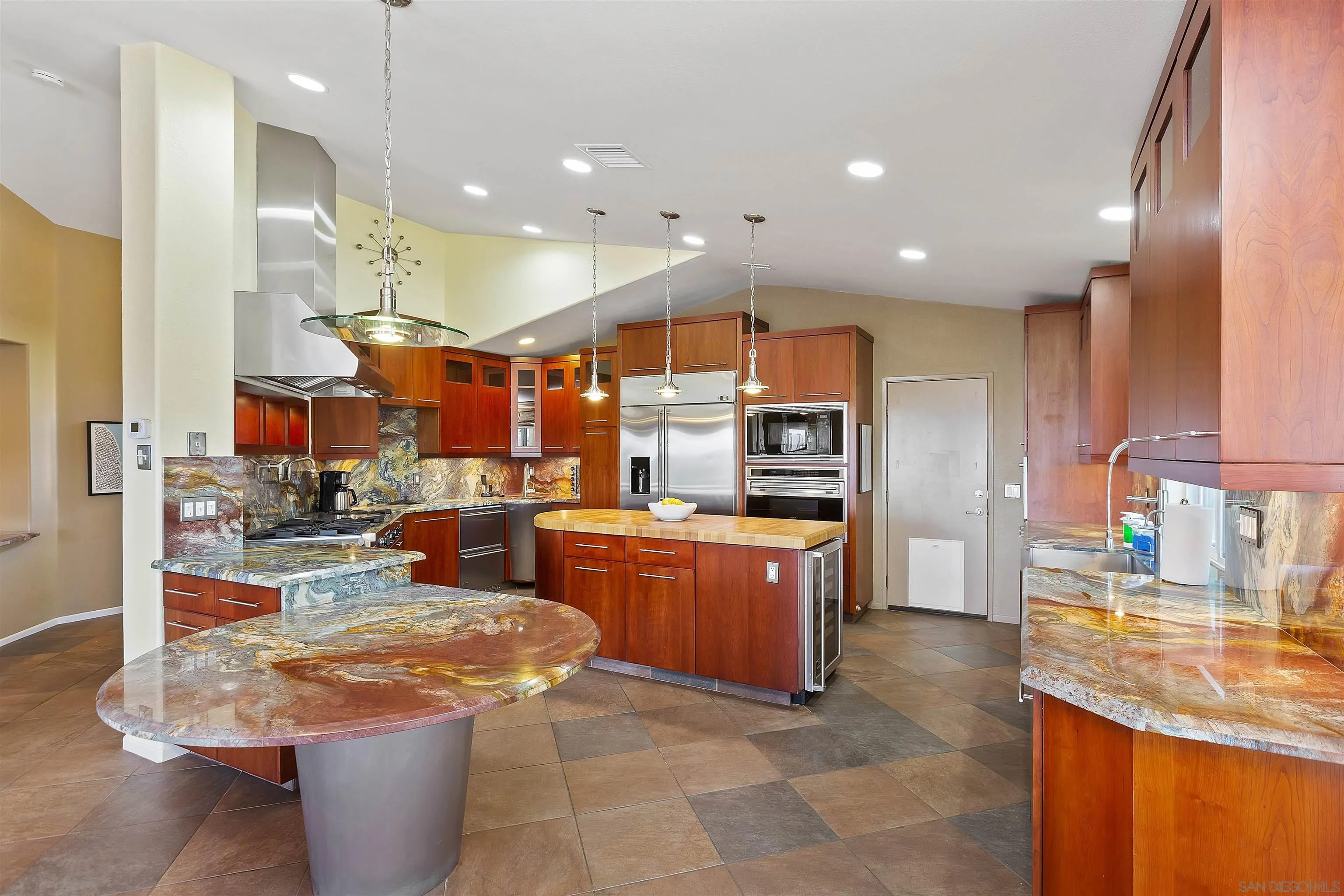 2703 Lobelia Road Alpine, CA 91901 - Photo 14 of 40 a kitchen with stainless steel appliances granite countertop a stove top oven a sink and a refrigerator