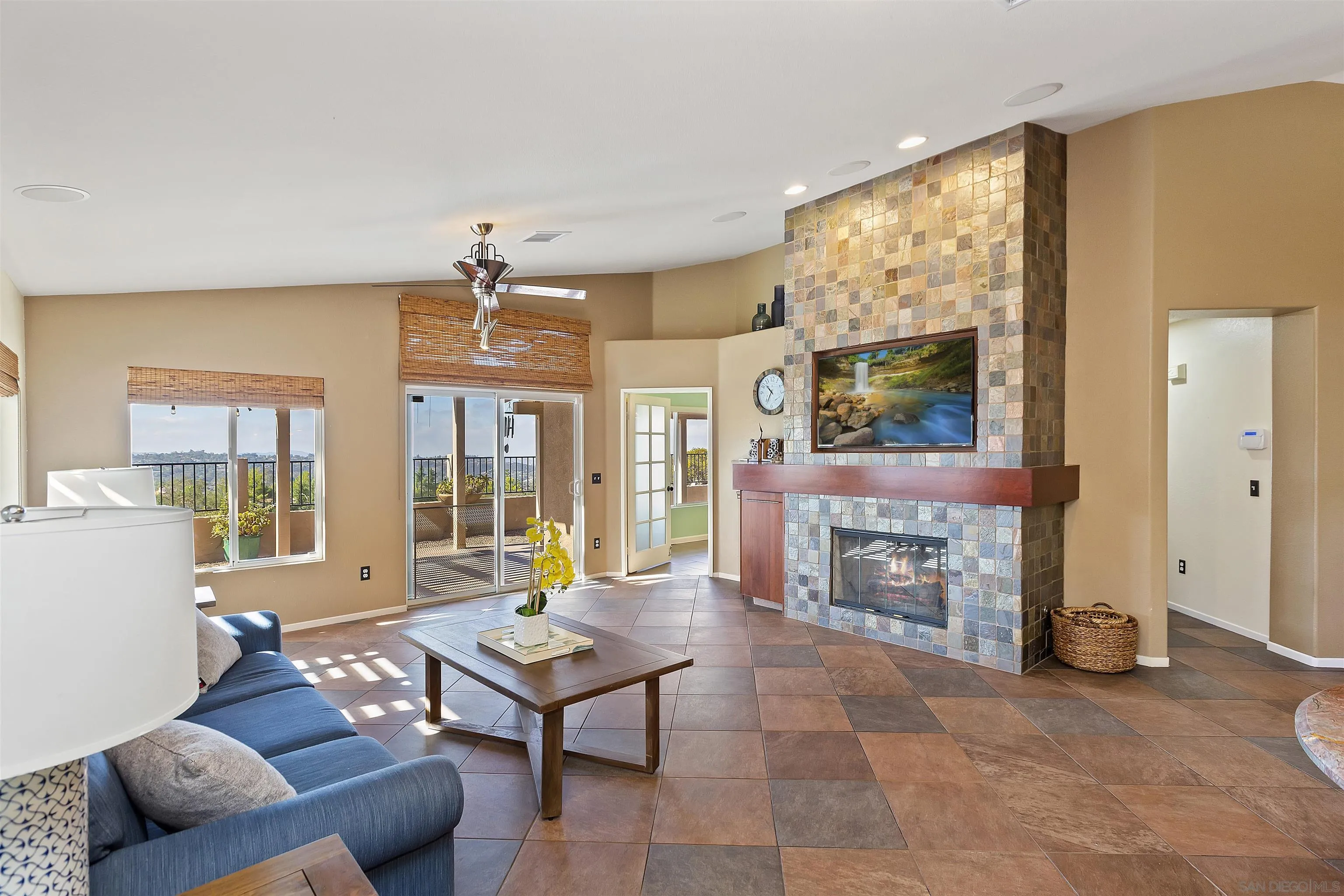 2703 Lobelia Road Alpine, CA 91901 - Photo 15 of 40 a living room with furniture a fireplace and a large window