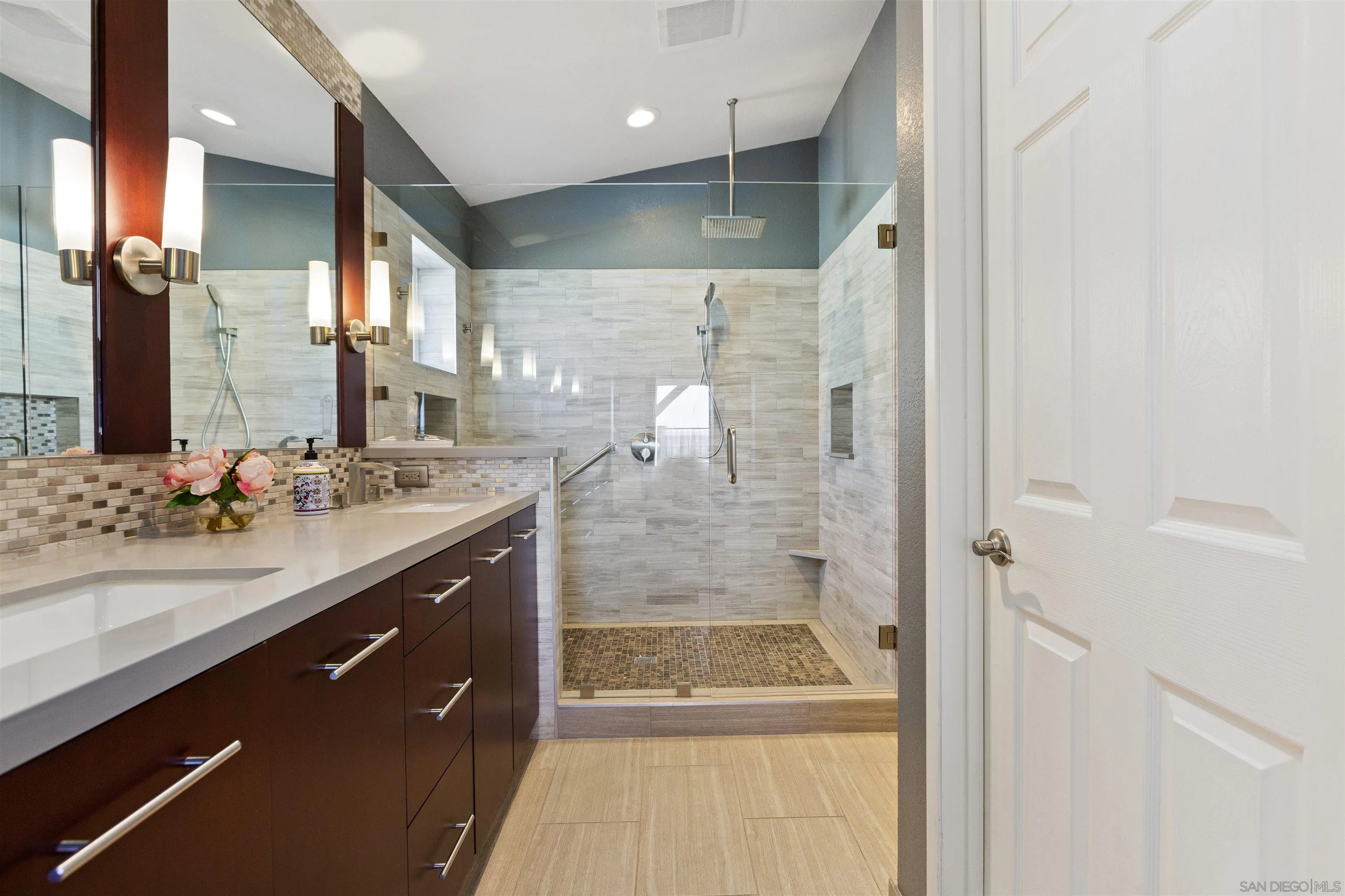 2703 Lobelia Road Alpine, CA 91901 - Photo 21 of 40 a bathroom with a shower sink and mirror