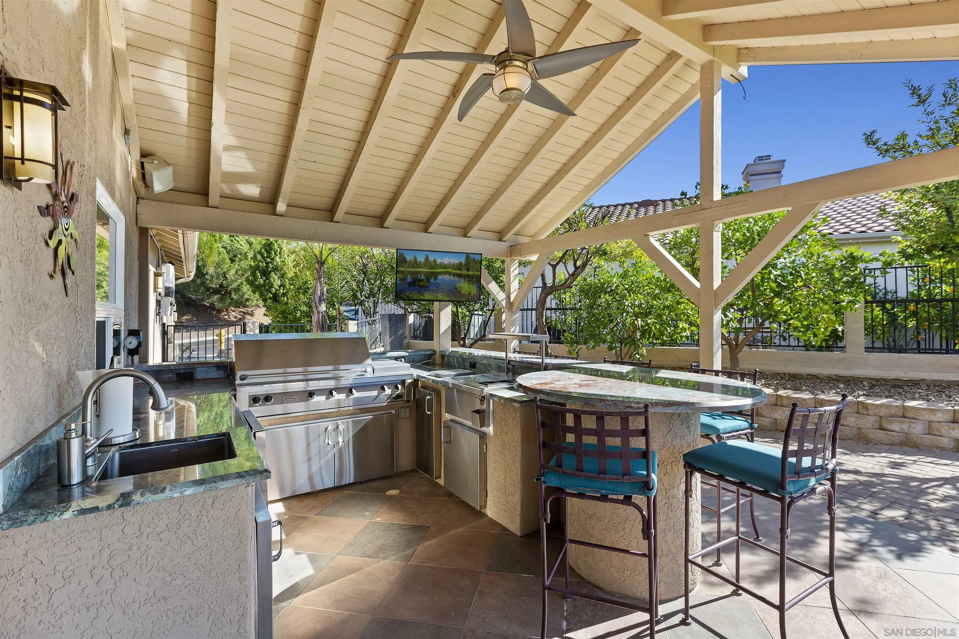 2703 Lobelia Road Alpine, CA 91901 - Photo 27 of 40 a view of a patio with table and chairs a barbeque grill with wooden floor and fence