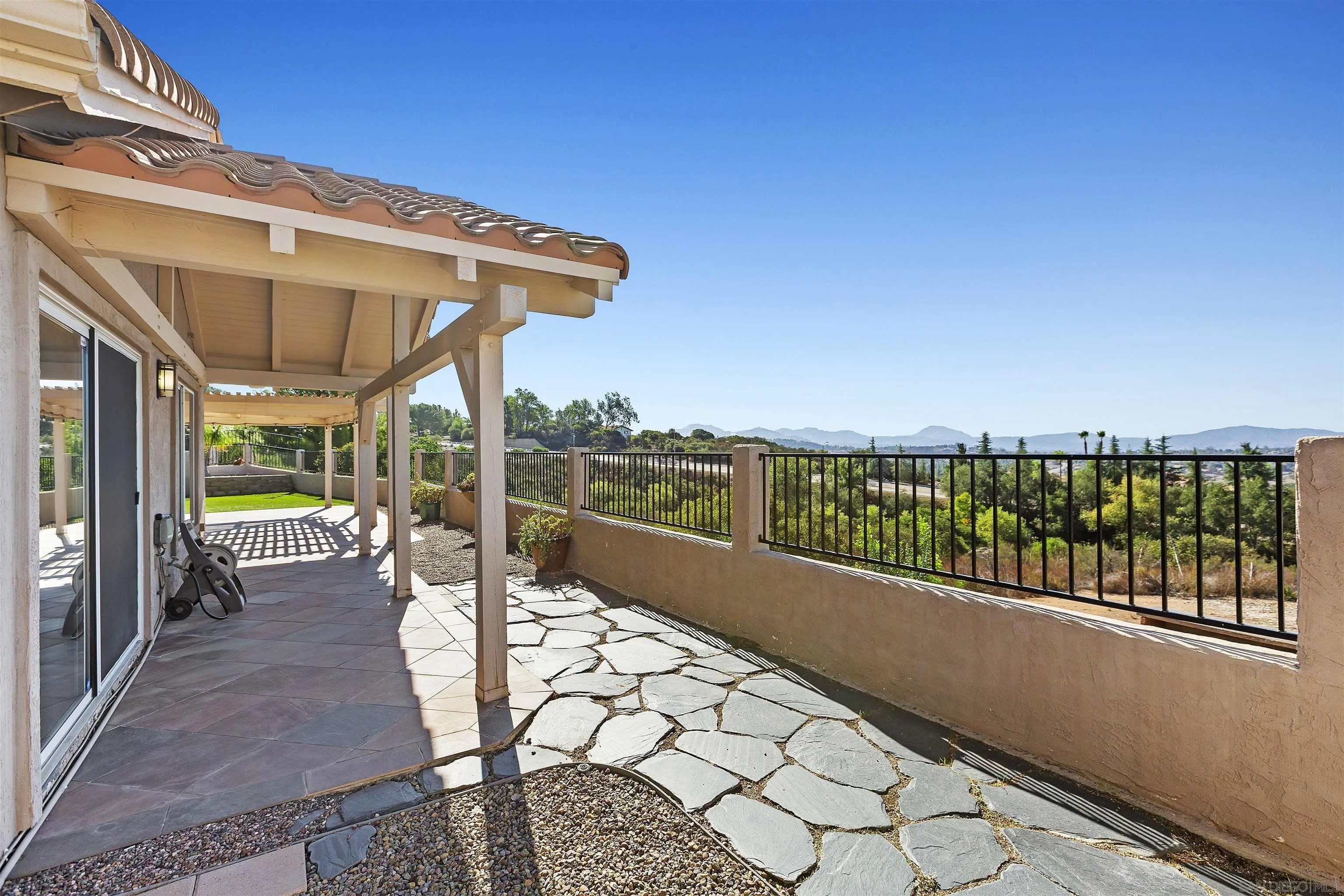 2703 Lobelia Road Alpine, CA 91901 - Photo 31 of 40 a view of a patio with a table chairs and backyard