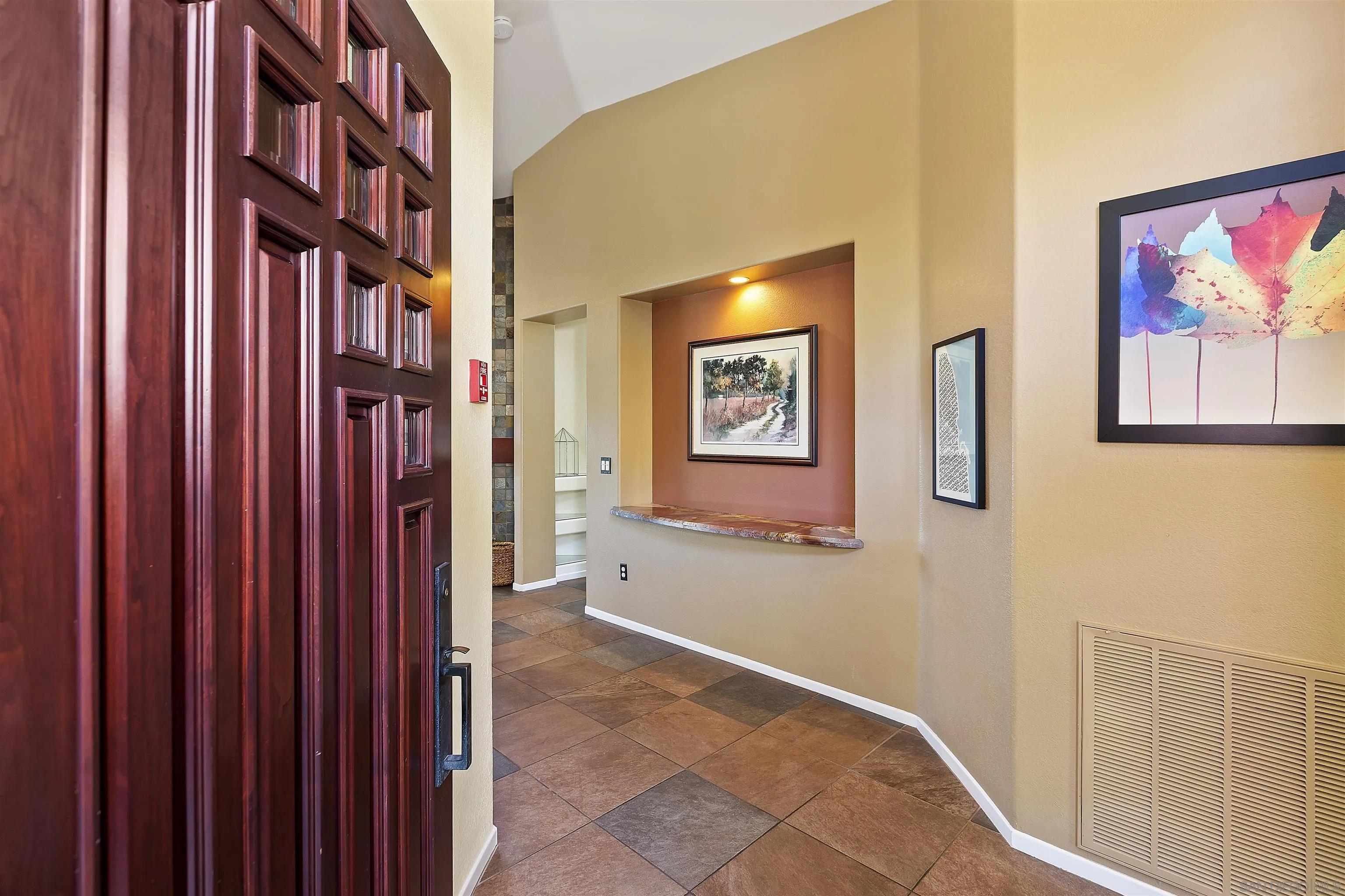 2703 Lobelia Road Alpine, CA 91901 - Photo 6 of 40 a view of an entryway with a flower pot and a bookshelf