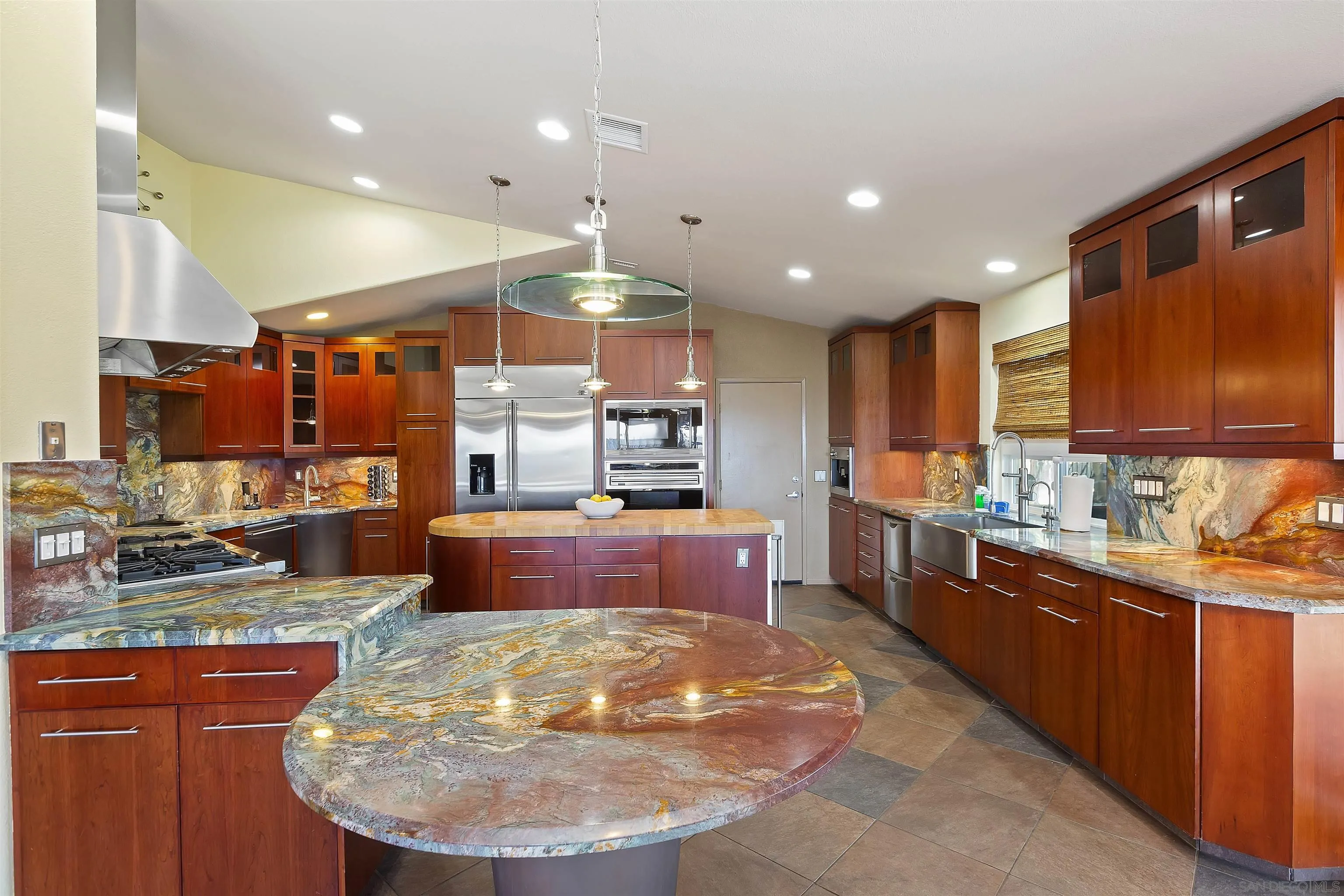 2703 Lobelia Road Alpine, CA 91901 - Photo 9 of 40 a kitchen with stainless steel appliances kitchen island granite countertop a stove and cabinets