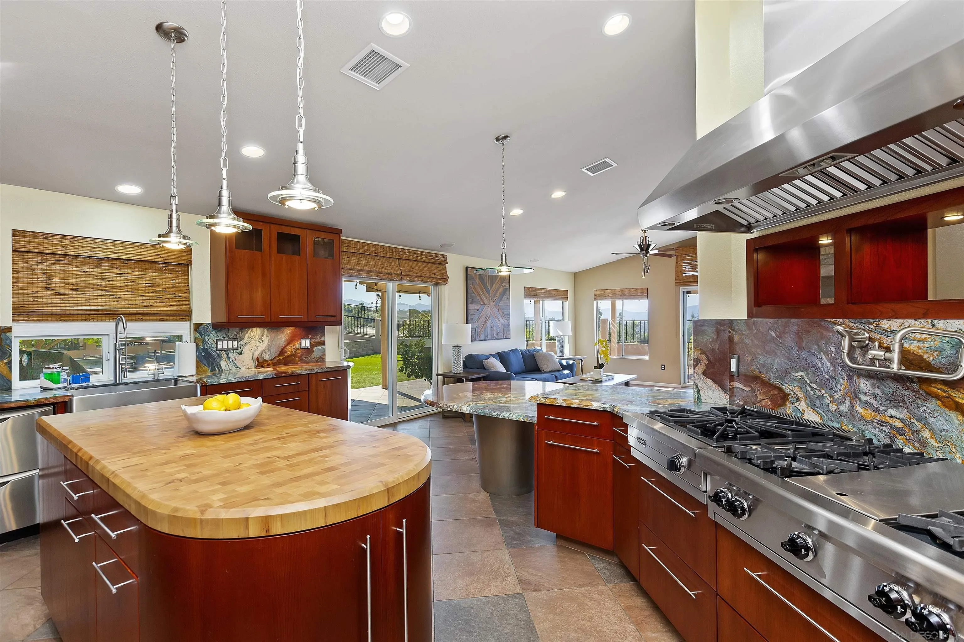 2703 Lobelia Road Alpine, CA 91901 - Photo 10 of 40 a kitchen with a stove a sink a microwave a dining table and chairs