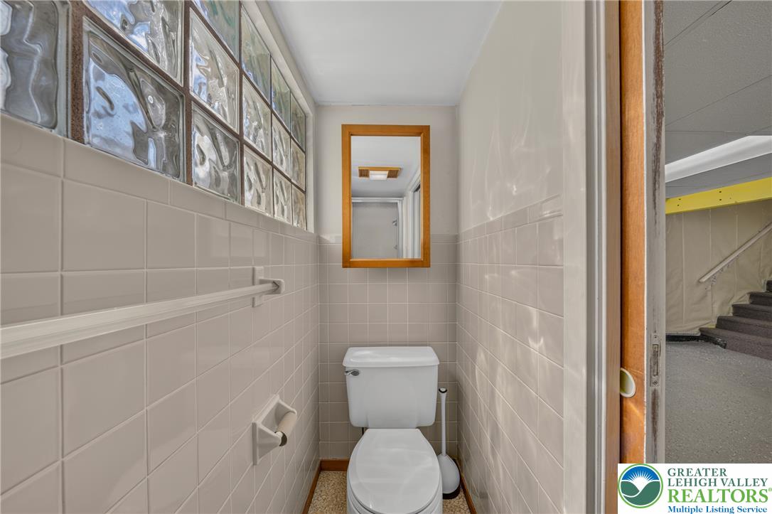 1814 Ruth Street Allentown, PA 18104 - Photo 43 of 54 Tiled walls and a glass block window accent this functional basement powder room.