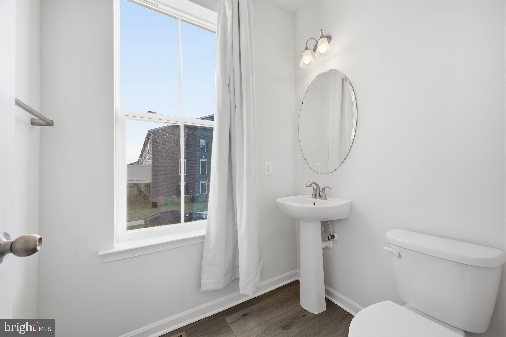 217 Southwind Drive Accokeek, MD 20607 - Photo 20 of 34 a bathroom with a sink a toilet and a mirror