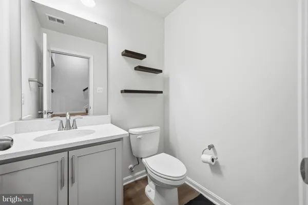 a bed sitting in a spacious bedroom next to a window and a larger closet