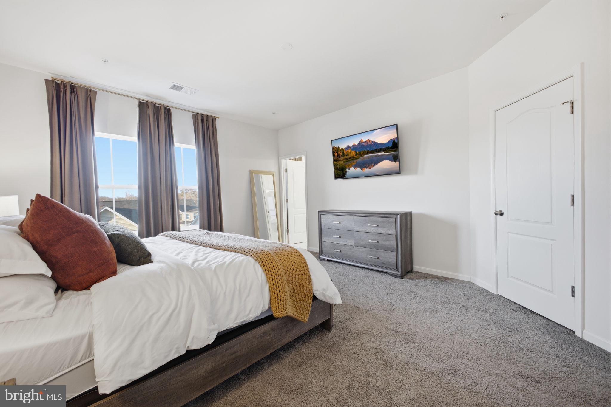 217 Southwind Drive Accokeek, MD 20607 - Photo 24 of 34 a bedroom with a bed and a painting on the wall