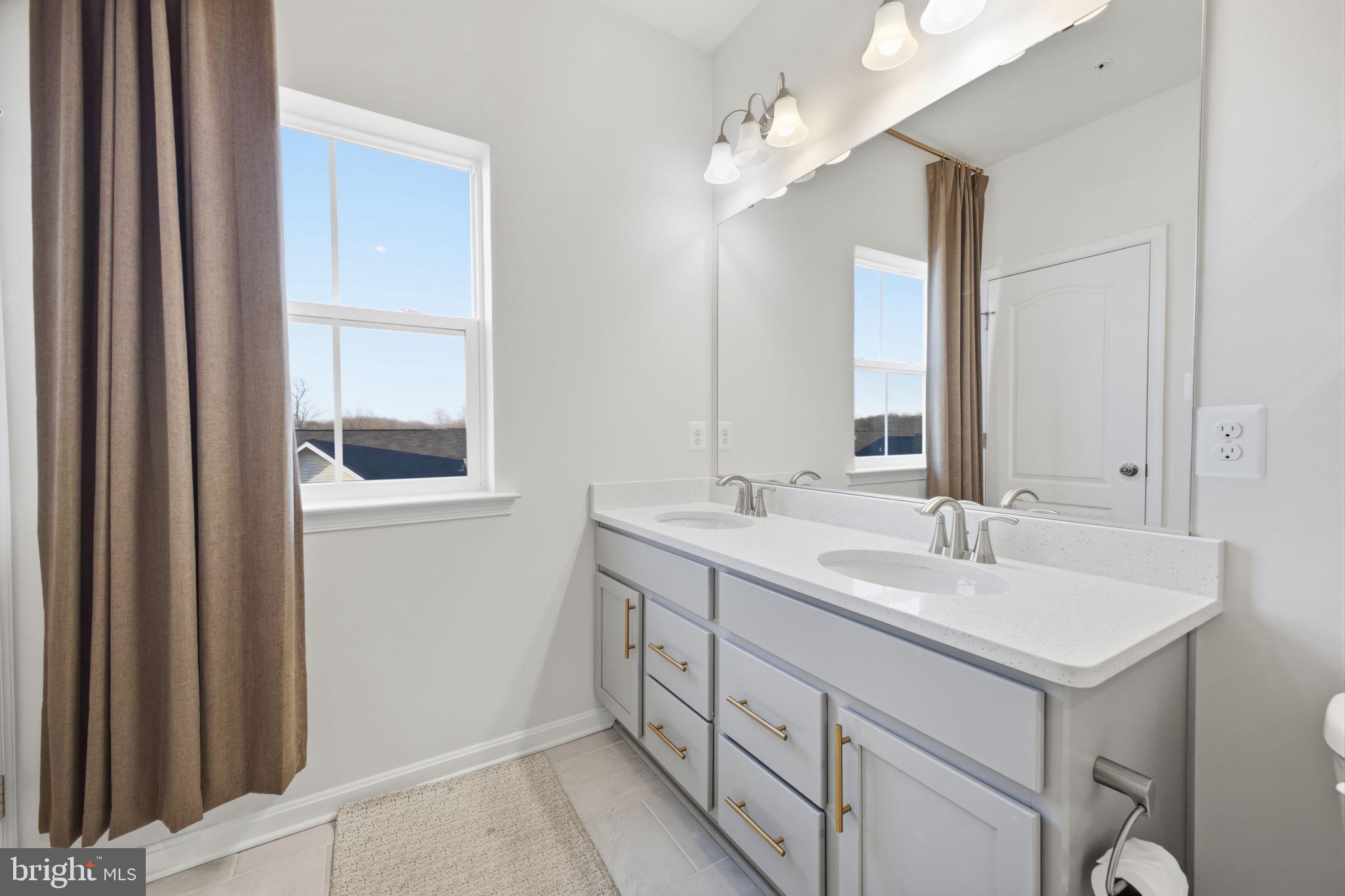 217 Southwind Drive Accokeek, MD 20607 - Photo 26 of 34 a bathroom with 2 sink and a mirror