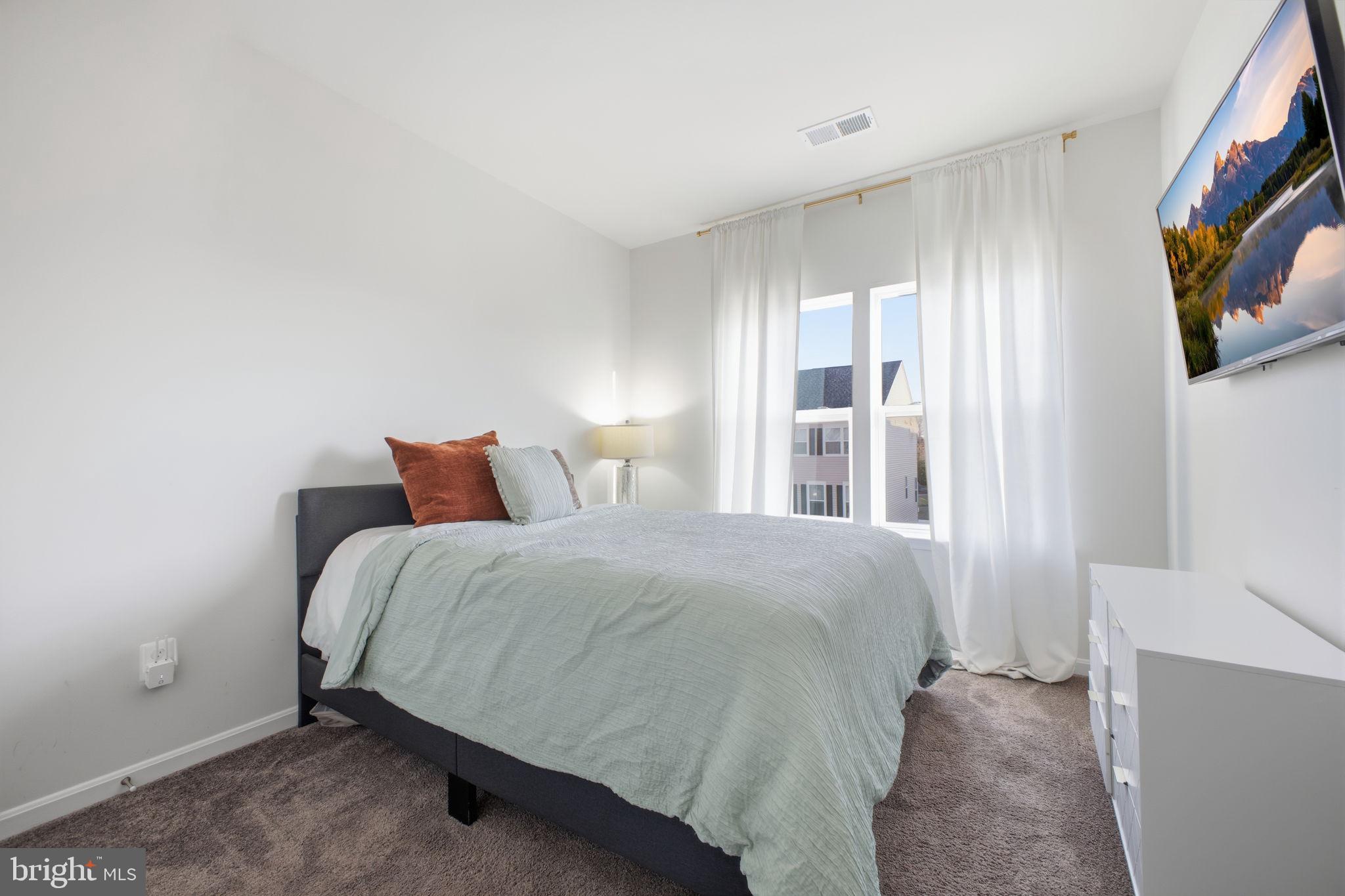 217 Southwind Drive Accokeek, MD 20607 - Photo 28 of 34 a bedroom with a bed and a flat screen tv