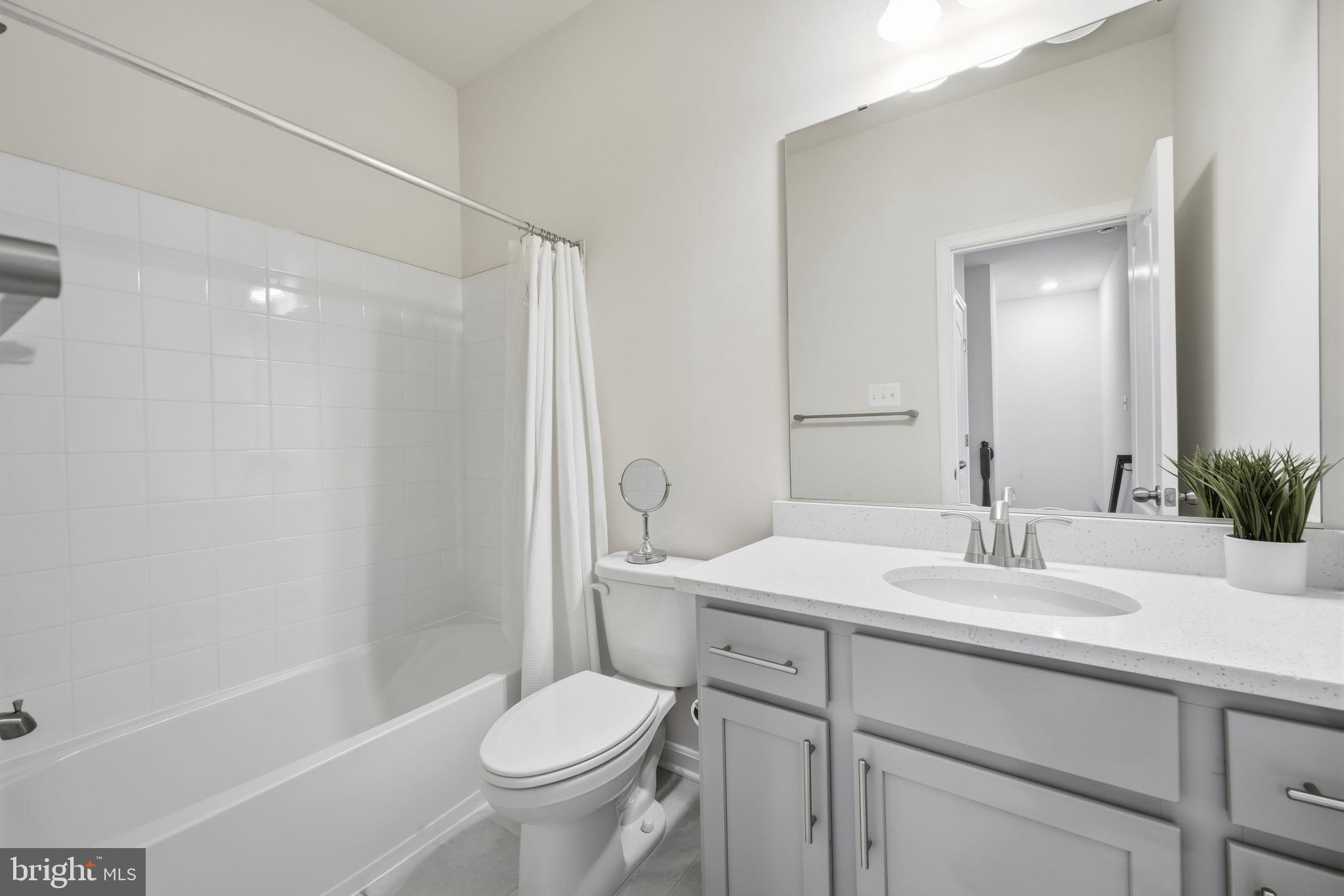 217 Southwind Drive Accokeek, MD 20607 - Photo 30 of 34 a bathroom with a sink a toilet and shower