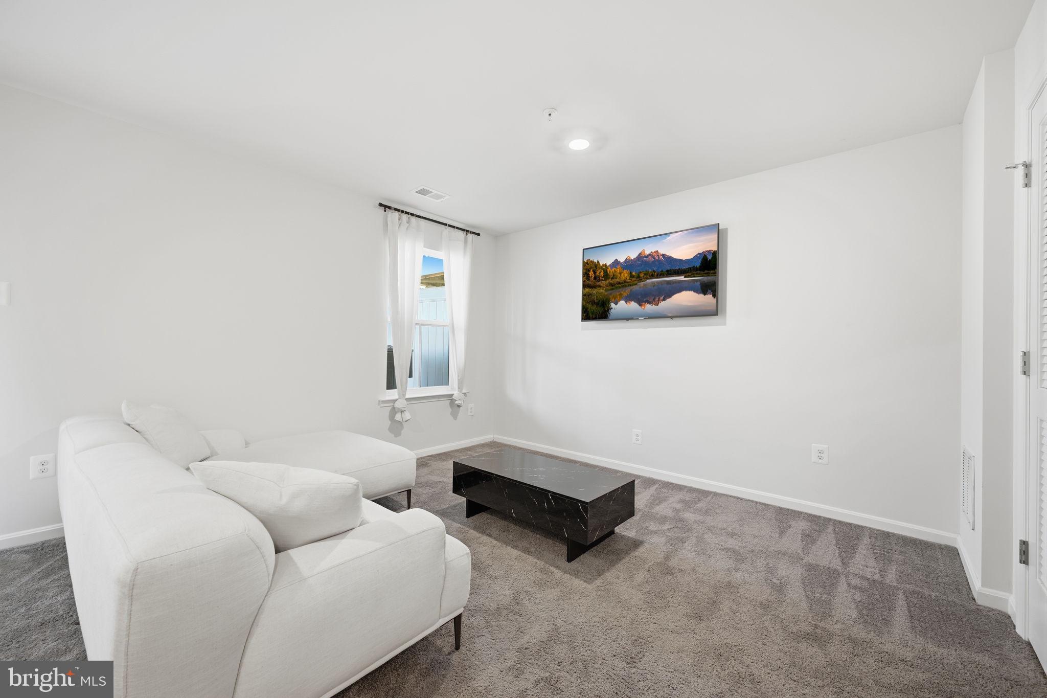 217 Southwind Drive Accokeek, MD 20607 - Photo 4 of 34 a living room with furniture and a flat screen tv