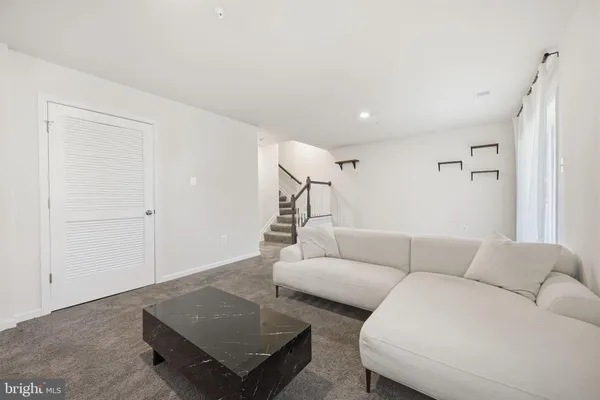 a large kitchen with stainless steel appliances a sink a counter top space and cabinets
