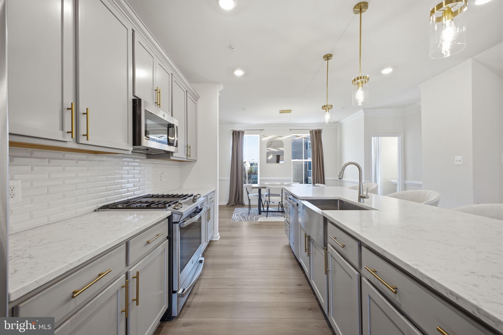 217 Southwind Drive Accokeek, MD 20607 - Photo 10 of 34 a kitchen with stainless steel appliances granite countertop a sink a stove and a wooden floors