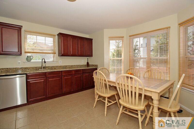 44 Cannon Road Old Bridge, NJ 08857 - Photo 6 of 24 a kitchen with a sink and wooden cabinets