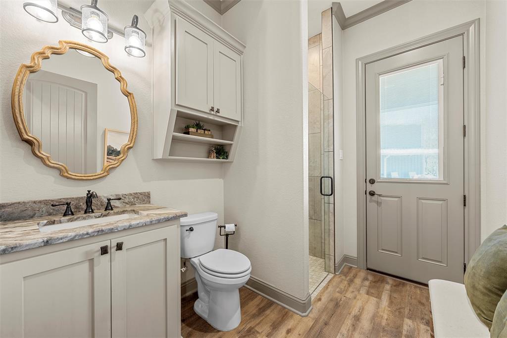 18503 Wortham Bend Road China Spring, TX 76633 - Photo 14 of 40 a bathroom with a toilet a sink a mirror and vanity