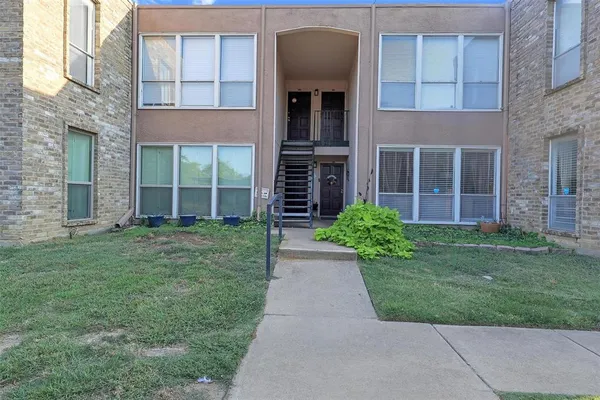 front view of a brick house with a yard
