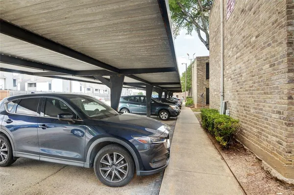 a view of garage with cars parked