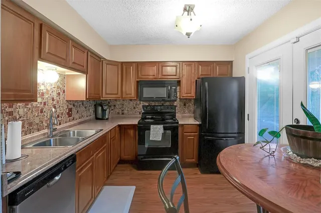 a kitchen with kitchen island granite countertop stainless steel appliances and a counter space