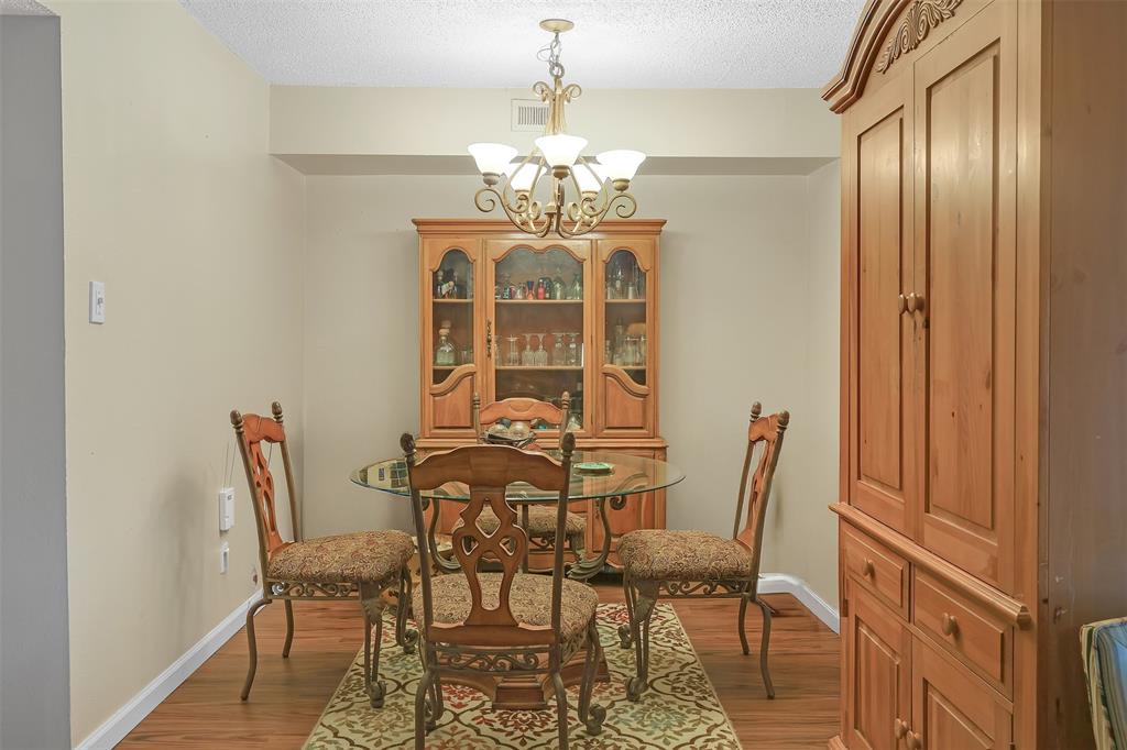 5624 Boca Raton Boulevard, Unit 133 Fort Worth, TX 76112 - Photo 6 of 19 a view of a dining room with furniture and chandelier
