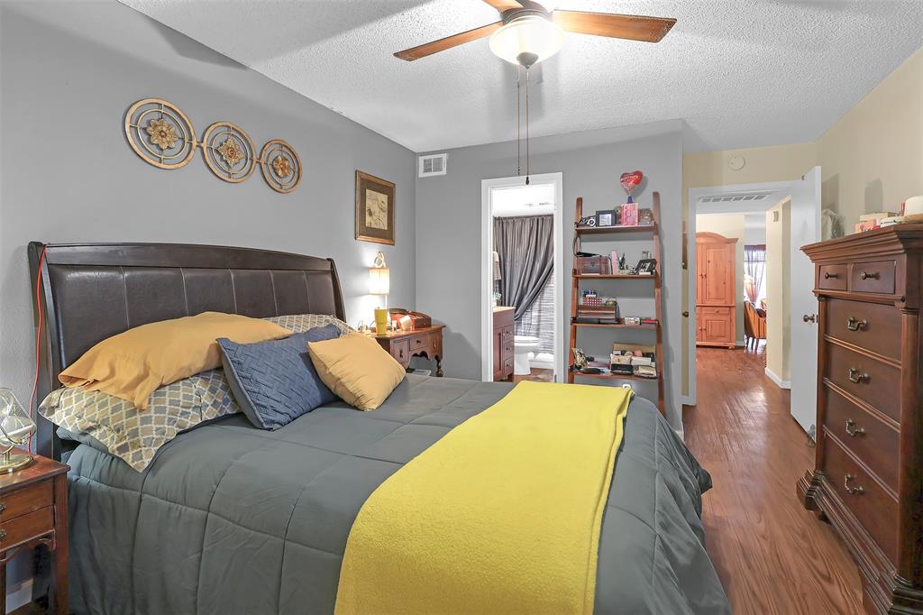 5624 Boca Raton Boulevard, Unit 133 Fort Worth, TX 76112 - Photo 7 of 19 a bedroom with a bed and dresser