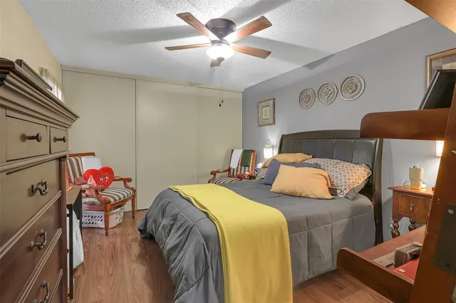 a bedroom with two beds and a chandelier